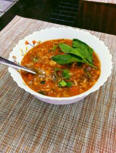 a bowl of soup with greens in it on a table at Hotel Himalayan in Madheso +48 photos