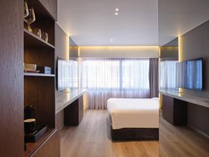 a hotel room with a bed and a window at Nur Edge Aparthotel - Acropolis Skyline in Athens