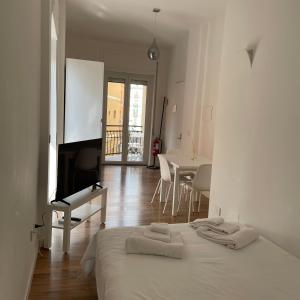 una camera bianca con letto e sala da pranzo di Tarantè a Napoli