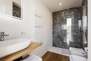 a bathroom with a white sink and a shower at Sanremissimo Rooms & Apartment in Sanremo +38 photos