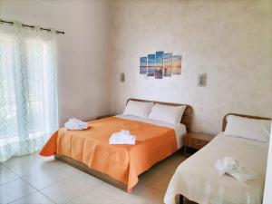 a bedroom with two beds with towels on them at Zio Tonino in Termoli