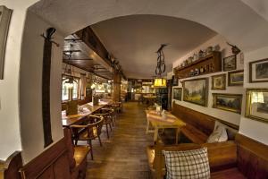 a dining room with wooden tables and chairs at Wirtshaus und Pension Hocheck in Ramsau