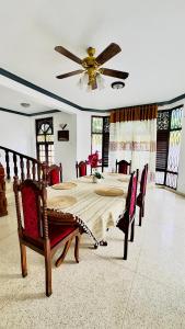 a dining room with a table and a ceiling fan at Yahana Beach Villa in Negombo +33 photos