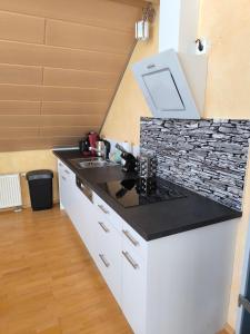 a kitchen with a sink and a counter top at Diane Appartement in Scheer