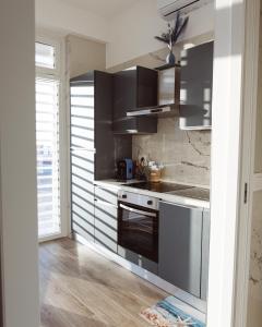 a kitchen with stainless steel appliances and a window at A'mare in Giovinazzo