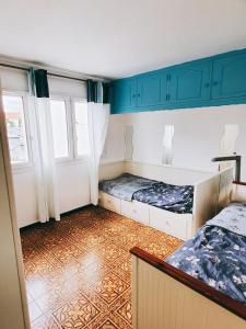 a room with two beds and a window at COSY BIG HOUSE near Paris, Roissy, big parking in Le Blanc-Mesnil