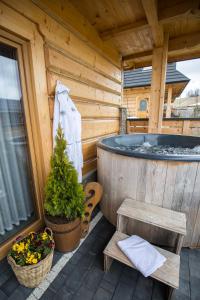 a cabin with a jacuzzi tub and a bench at Luxury Houses & Apartments Zaliński in Zakopane +182 photos
