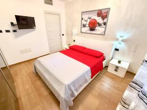a bedroom with a large bed with a red blanket at Casa Selema in Donigala Fenughedu