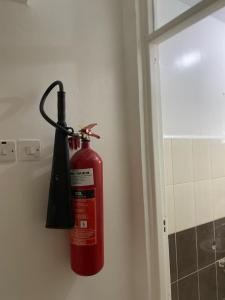 a fire extinguisher is hanging on a wall at Goodness in Nairobi