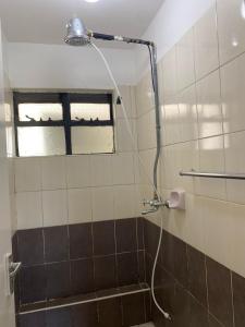 a shower in a bathroom with a window at Goodness in Nairobi