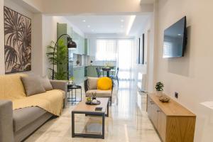 a living room with a couch and a table at Ameda Luxury Apartments in Kos Town