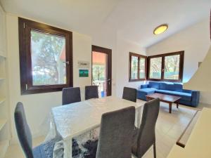 a dining room with a table and chairs at Villa dell'Arte Vista Mare in Villasimius