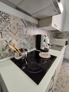 a kitchen with a stove with a pot on it at Giomasue' in Porticello +30 photos