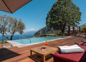 a villa with a view of the ocean and a pool at Capri Wine Hotel in Capri