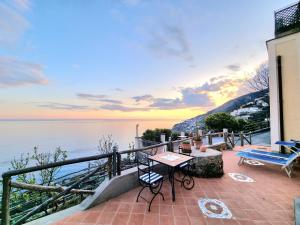 a house with a balcony with a view of the water at Il Limoneto in Furore