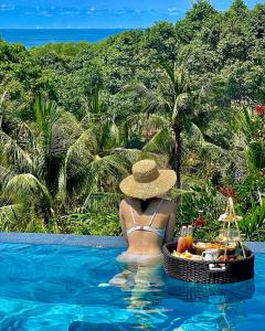 a woman in a hat sitting in a swimming pool at Lahana Resort Phu Quoc & Spa in Phú Quốc +37 photos