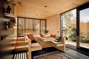 a living room with a couch and a large window at Zwier, de Vrijhaven in Vinkeveen