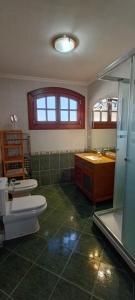 a bathroom with two toilets and a sink and a shower at La casika del Cerro in Rasines +33 photos