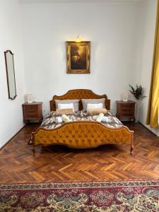 a bedroom with a large bed with a rug at Velez Ház in Budapest