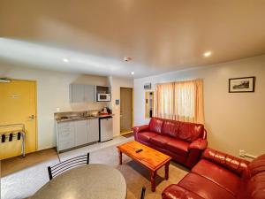 a living room with a couch and a table at Bealey Avenue Motel in Christchurch