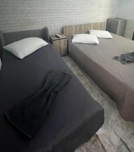 two beds sitting next to each other in a room at Casa Elena in Constanţa +1 photo