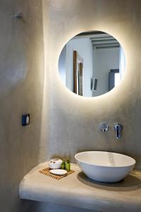 a bathroom with a sink and a mirror at Villa Camelia 2 - Psarou View - Private pool and Jacuzzi in Mýkonos City +27 photos