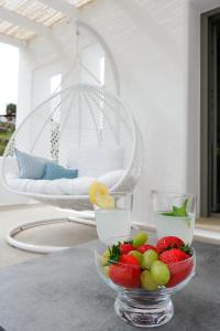 a bowl of fruit on a table in a living room at Villa Camelia 2 - Psarou View - Private pool and Jacuzzi in Mýkonos City