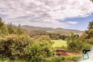 a view of a golf course in the hills at Hotiday Apartments Portoferraio in Portoferraio