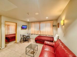 a living room with a couch and a table at Bealey Avenue Motel in Christchurch