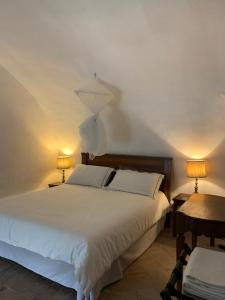 a bedroom with a large white bed with two lamps at Castello Farnese, Roma, sulla Via Francigena in Rome