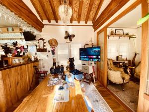 a living room with a table and a tv at Villa de Mory in Daegu