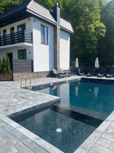 a swimming pool in front of a house at Stupari in Shaian