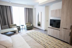 a living room with a tv and a couch and a table at Unit For Living in Beirut