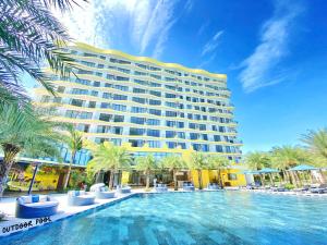 a hotel with a swimming pool in front of a building at Luxury SeaView Apartment in 5 star Resort, An Bàng - Hội An in Dien Ban