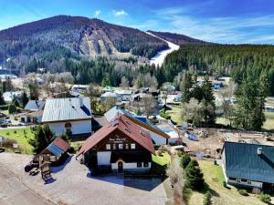 an aerial view of a small town with a mountain at Pension Ploc in Harrachov