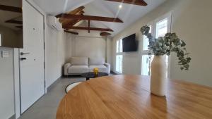 - un salon avec une table et un vase fleuri dans l'établissement Navas PentHouse 301 By Florentia Homes, à Grenade