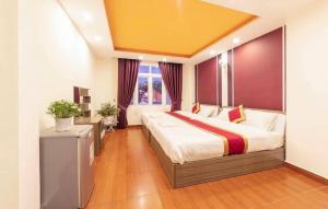 a bedroom with a large bed and a yellow ceiling at ROSE HOSTEL DALAT in Da Lat +27 photos
