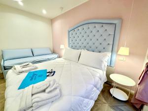 Postel nebo postele na pokoji v ubytování Hotel Astigiana & Appartamenti