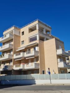 a tall apartment building with balconies on a street at Design a PSG con aria condizionata in Porto San Giorgio