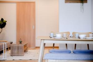 a table with bowls and cups on it in a room at Kawa in Kyoto