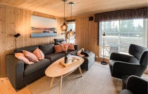 a living room with a couch and a table at Stunning Home In Sjusjøen With Sauna in Sjusjøen
