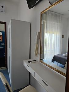A bed or beds in a room at Hotel Sara*** Cesenatico