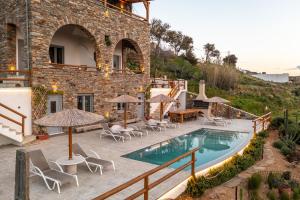 a resort with a swimming pool and chairs and umbrellas at Villa Papa in Glinádhon