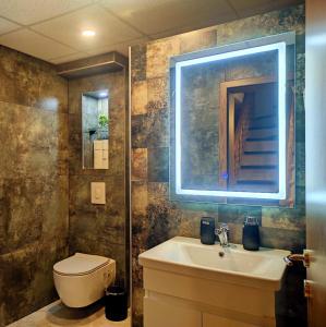 a bathroom with a sink and a toilet and a mirror at Villa Lena in Ohrid +20 photos