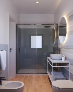 a bathroom with a glass shower and a sink at Lu' Hotel Porto Pino in SantʼAnna Arresi