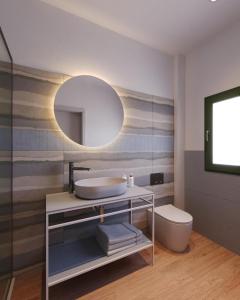 a bathroom with a sink and a mirror at Lu' Hotel Porto Pino in SantʼAnna Arresi