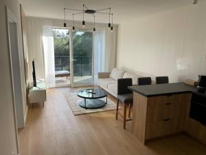 a living room with a couch and a table at Apartament BRYZA Marina Borki in Augustów
