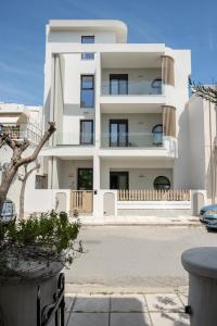 a white building with a lot of windows at Ameda Luxury Apartments in Kos Town