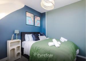a bedroom with two beds with blue walls at BIG House for Business Stays in Barnsley with 6-bedrooms & 8 Beds by PureStay in Barnsley