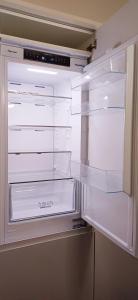 an empty refrigerator with its door open in a kitchen at Spacious 4 Bedroom House-2 bathrooms-Contractor-Family-Relocation-Professionals-Parking-Close-to-All-Amenities in Luton